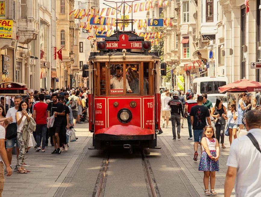Busy view of İstiklal Caddesi Street with people near CVK Hotels