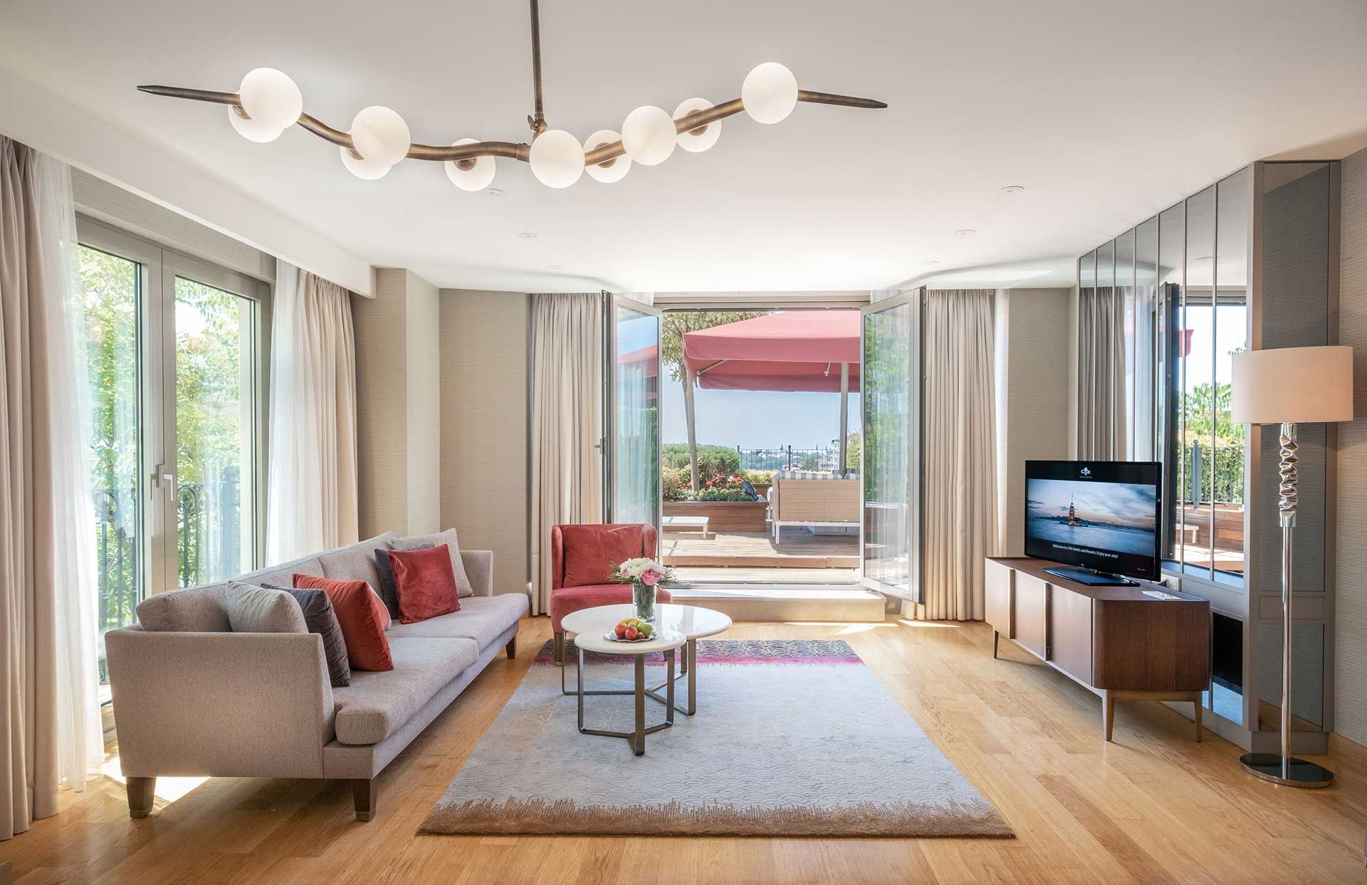 Living space with a sofa & TV in Two Bedroom Suite with Bosphorus View at CVK Park Prestige Suites Istanbul