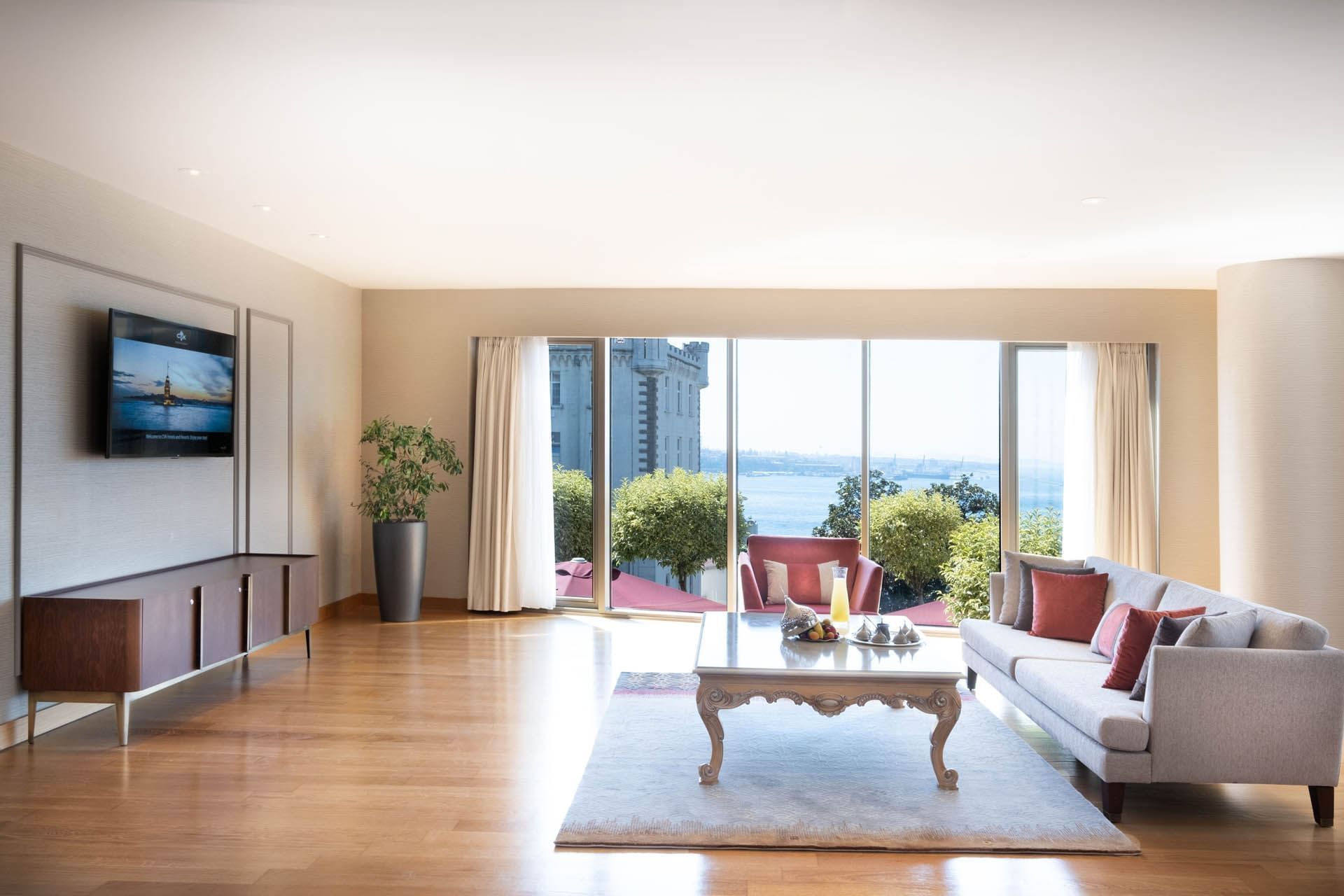 Spacious living space with a cozy sofa in One Bedroom Bosphorus View Suite at CVK Park Prestige Suites Istanbul