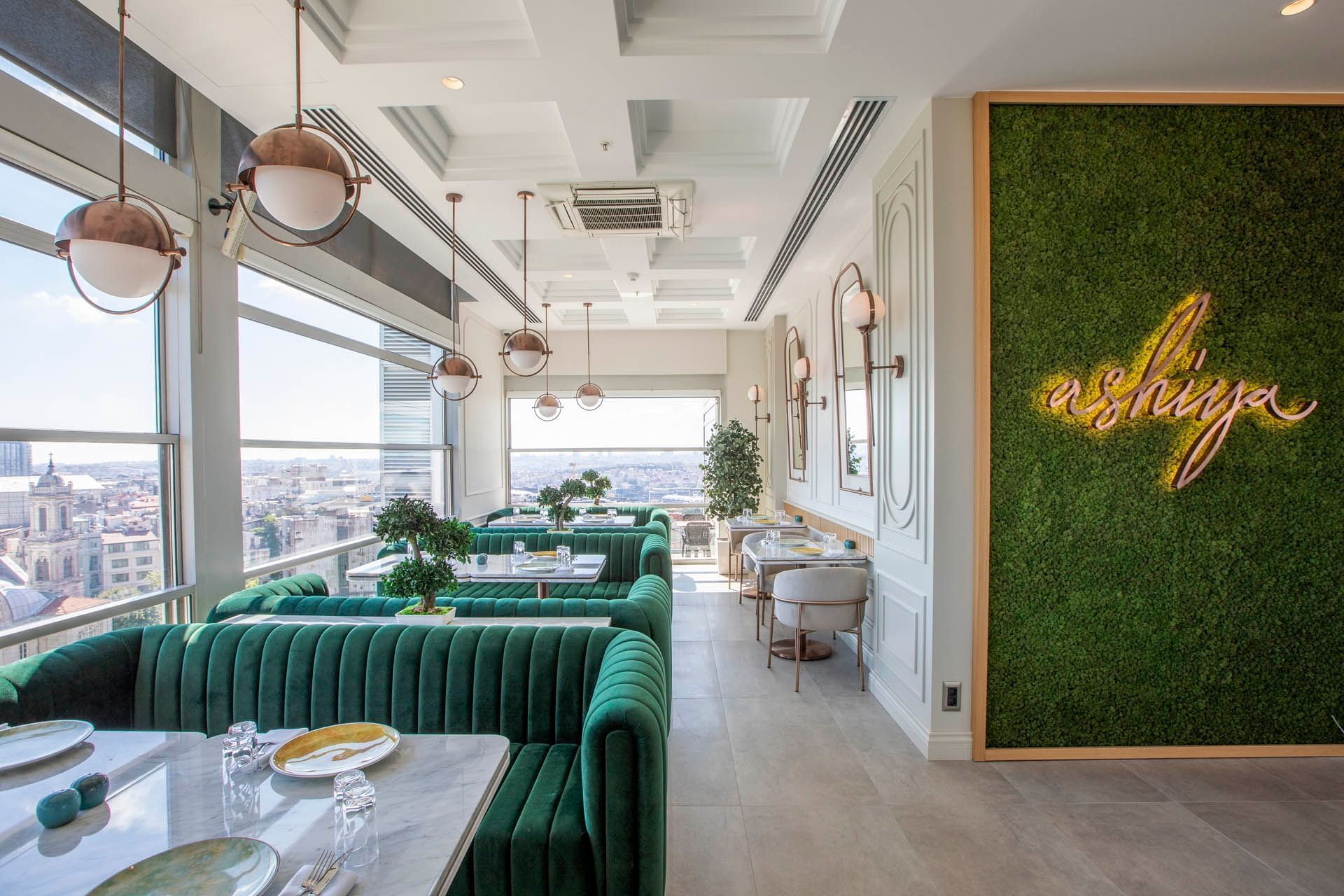 Dining area with plush seating & city view in Ashiya Restaurant & Terrace Bar at CVK Taksim Hotel Istanbul