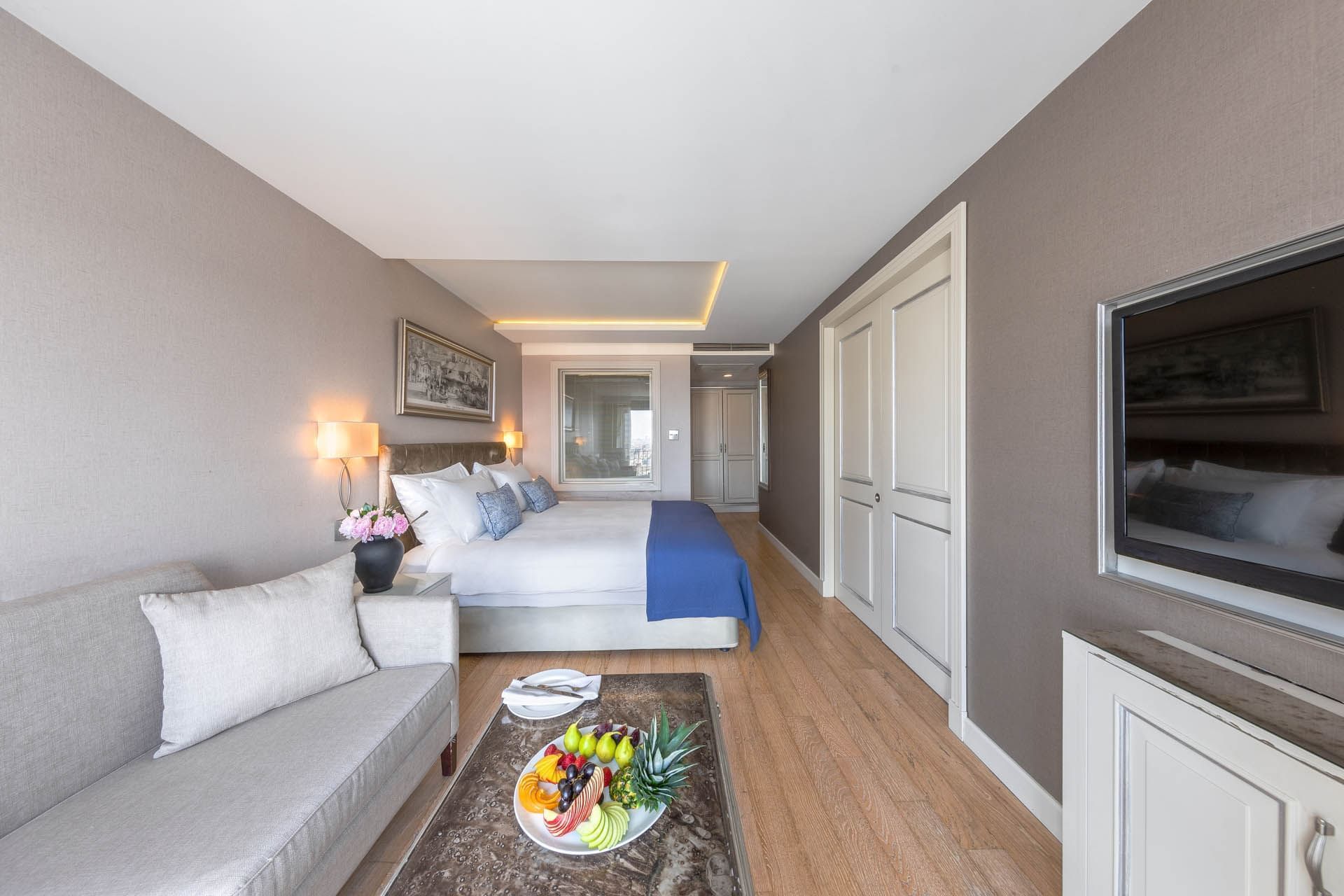 TV lounge area by the king bed in Deluxe Taksim Square View Room at CVK Taksim Hotel Istanbul