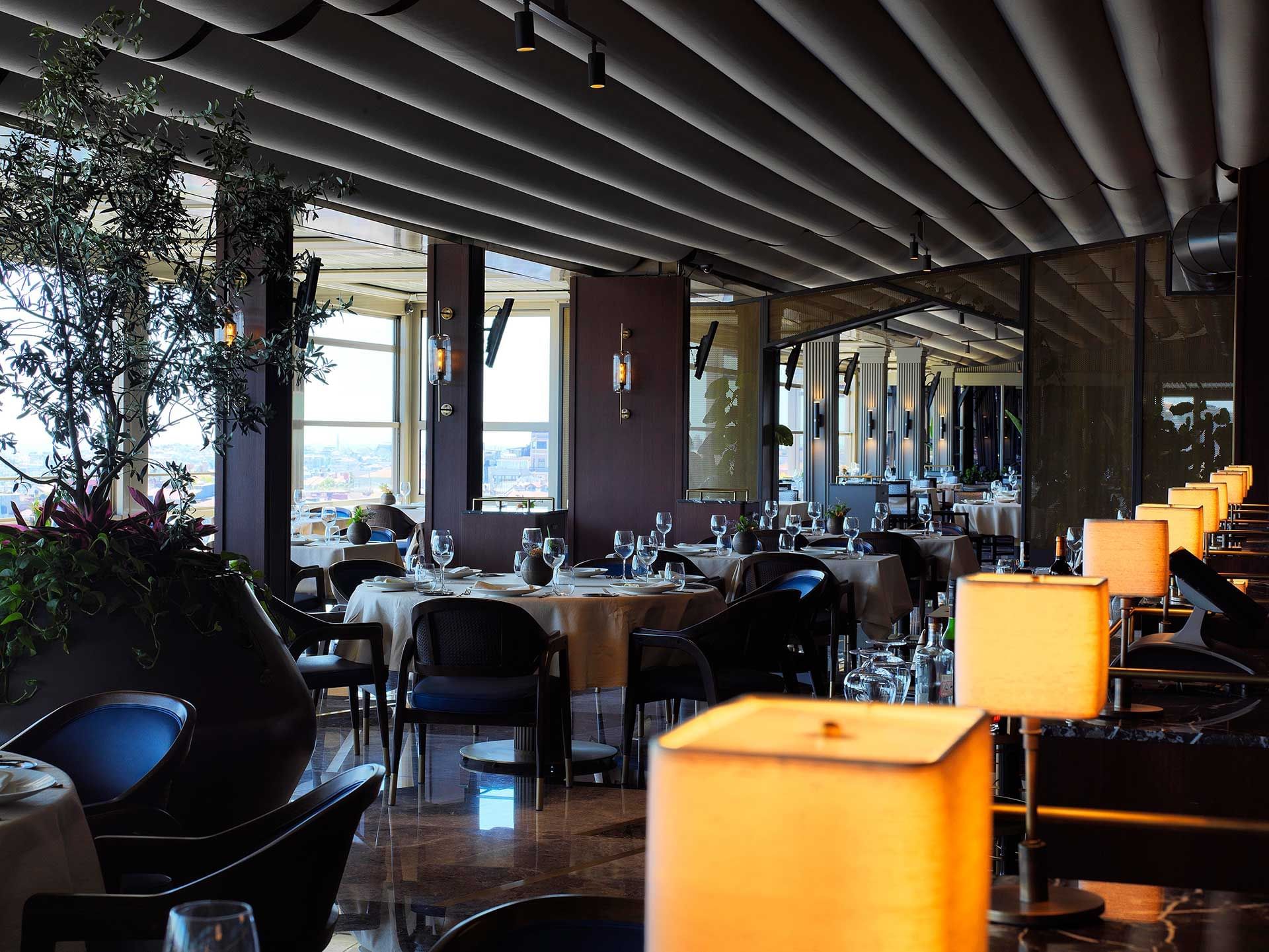 Interior of Izaka Terrace featuring dining tables and soft lighting at CVK Park Prestige Suites Istanbul