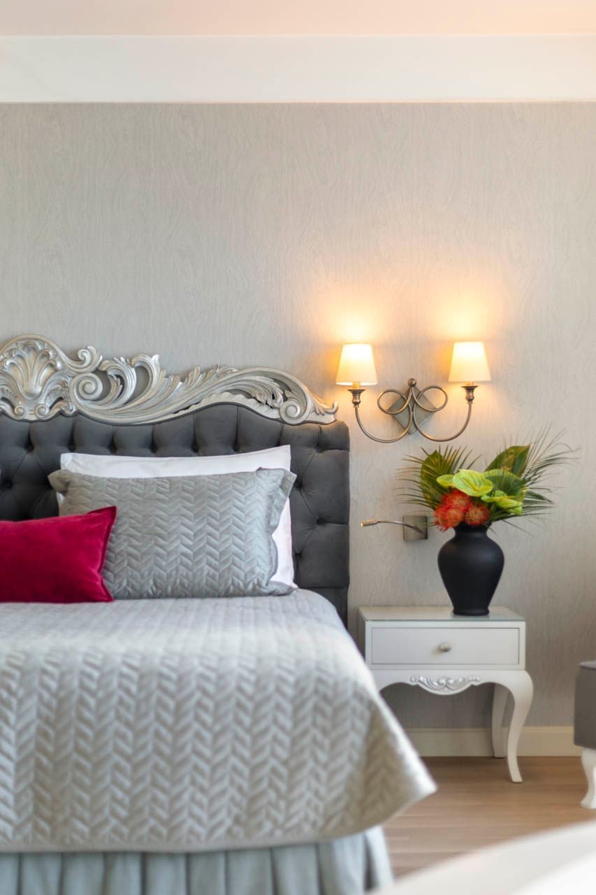 Cozy king bed with pillows and a flower vase in Luxury Suite at CVK Taksim Hotel Istanbul