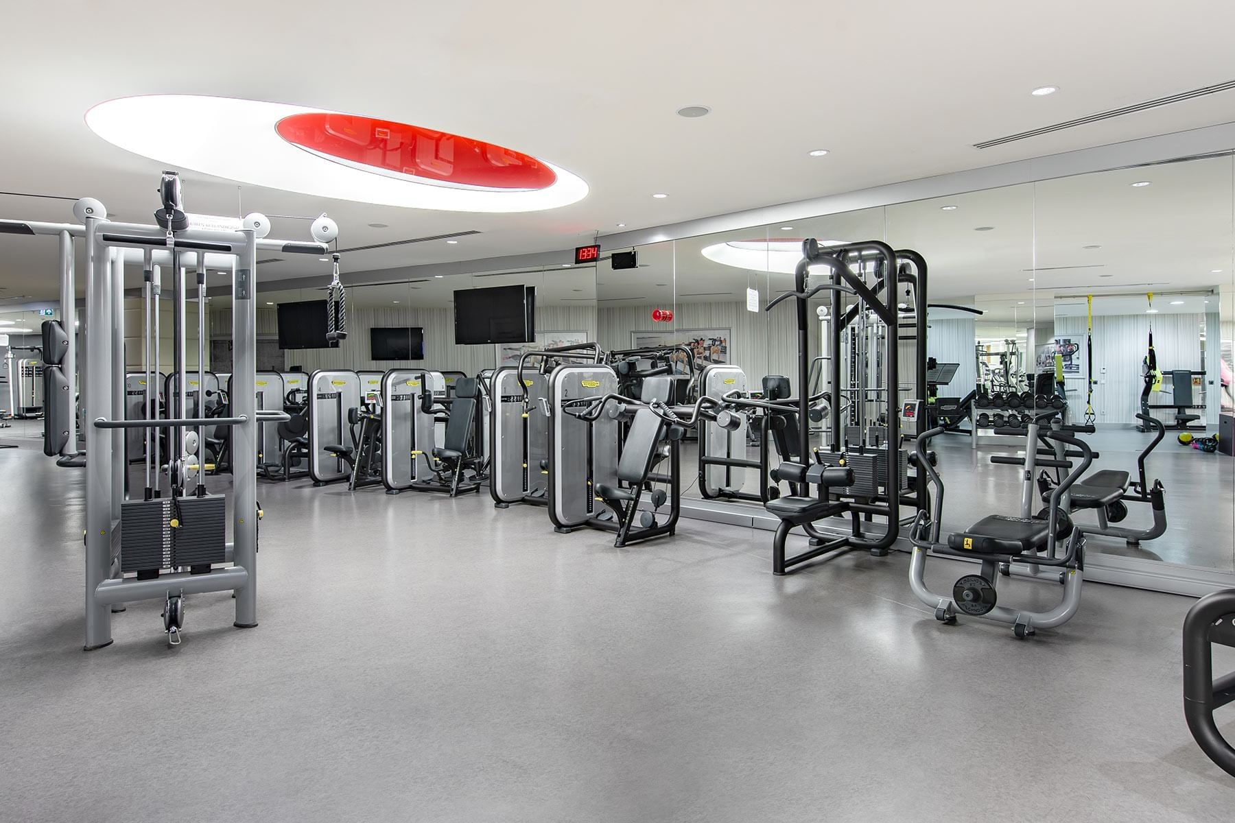 Gym interior featuring various exercise machines and mirrors at CVK Taksim Hotel Istanbul