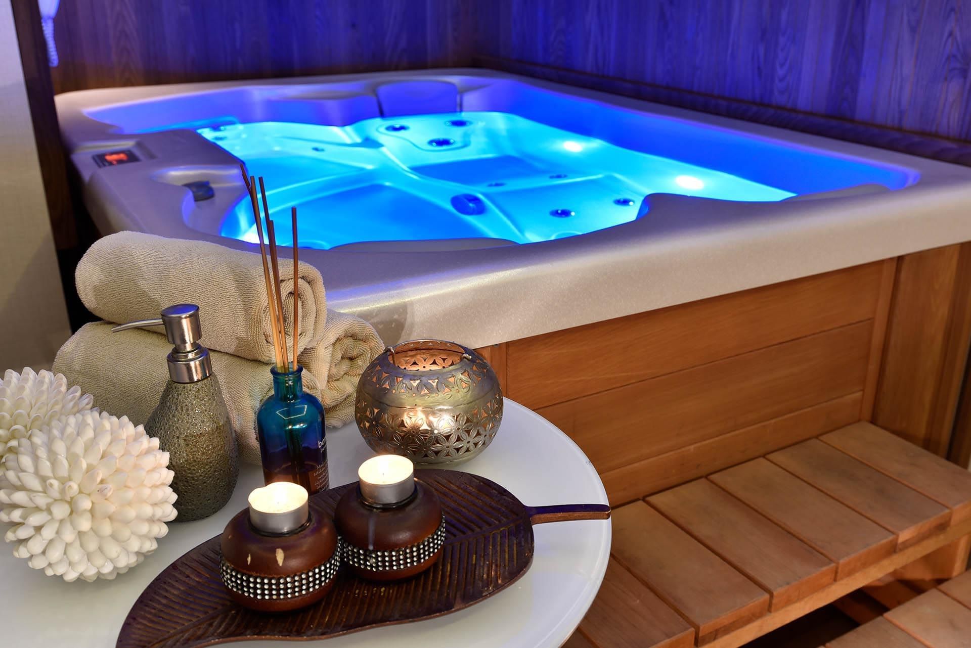 Tray of towels & spa amenities by the hot tub illuminated in blue light in Angkor Wat Spa at CVK Taksim Hotel Istanbul