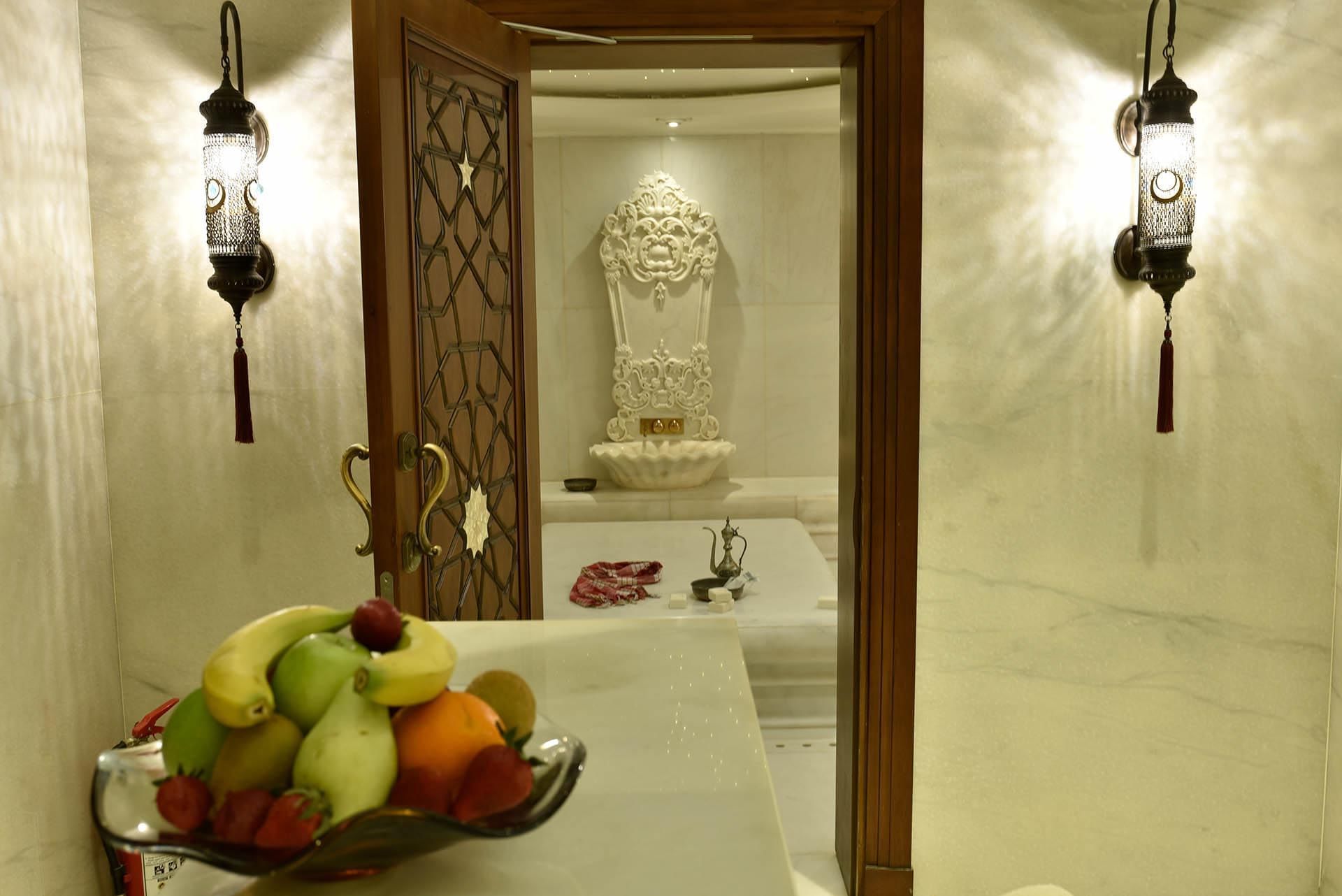 Marble hammam entrance with a fruit bowl on a marble countertop at CVK Taksim Hotel Istanbul