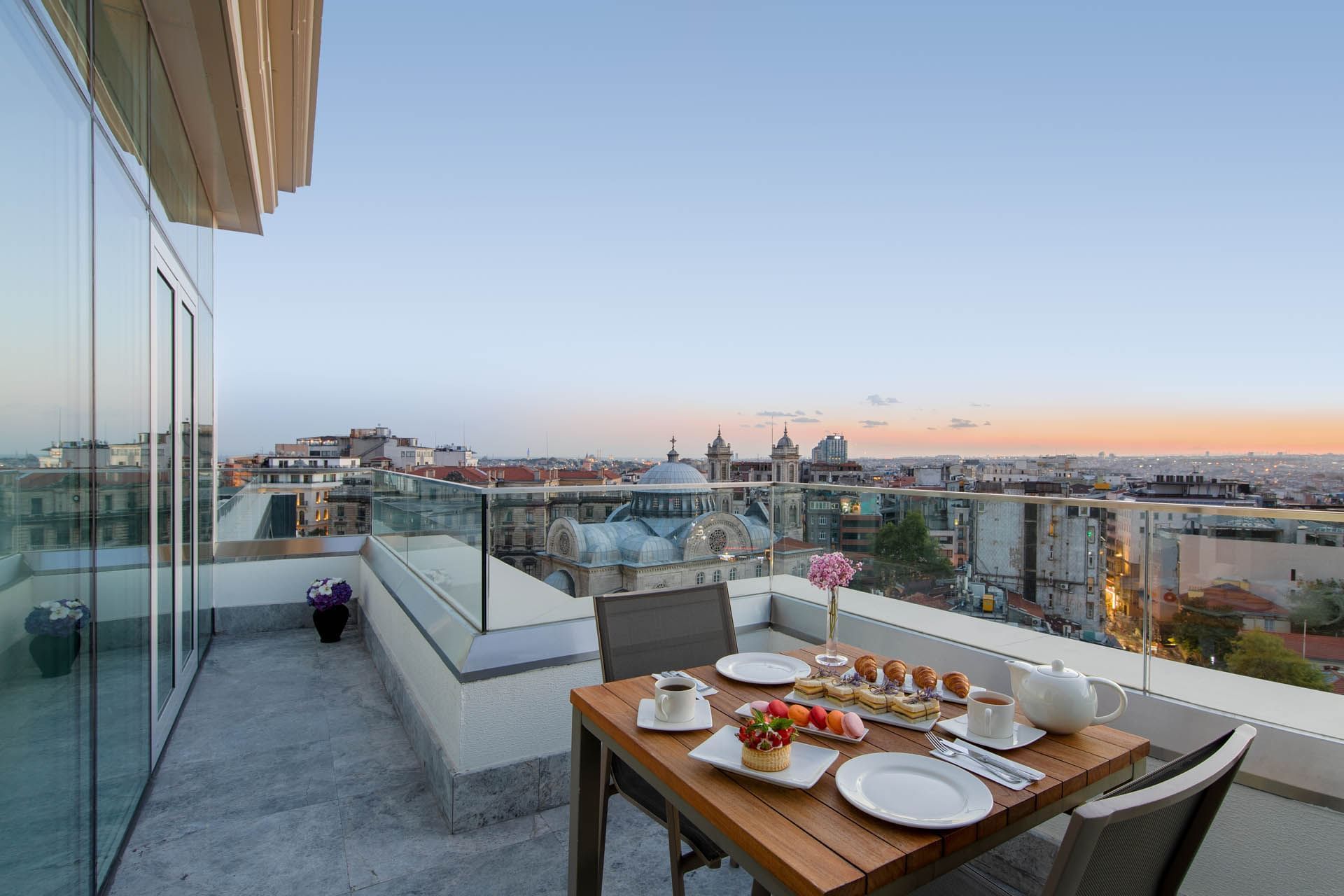 Balcony lounge area overlooking the city in Taksim Terrace Suite at CVK Taksim Hotel Istanbul