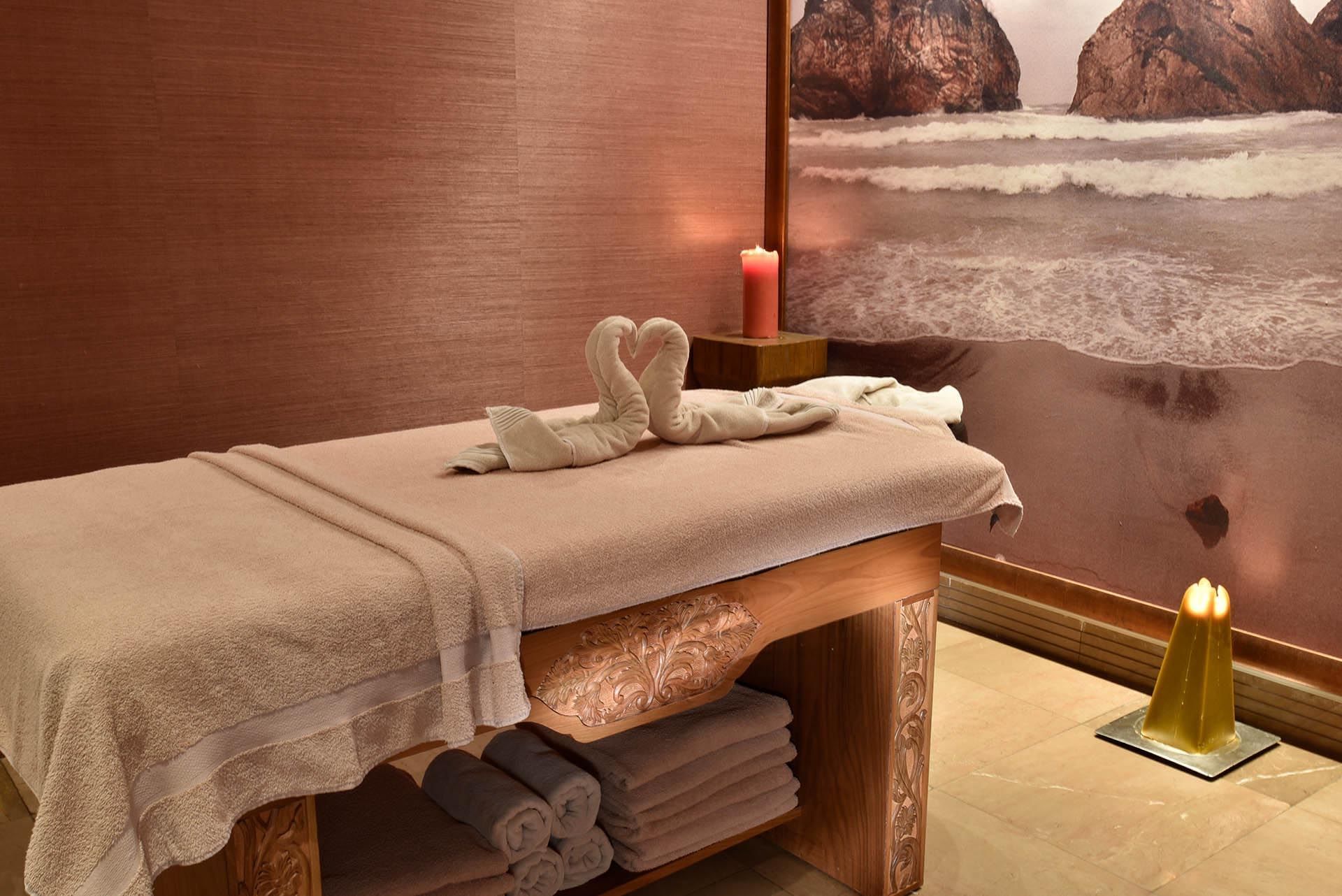 Massage table with heart-shaped towel swans in Angkor Wat Spa at CVK Taksim Hotel Istanbul